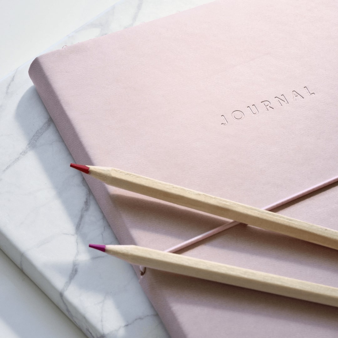 Pink journal two pencils